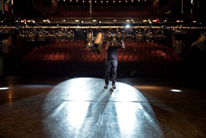 staff member adjusting lights