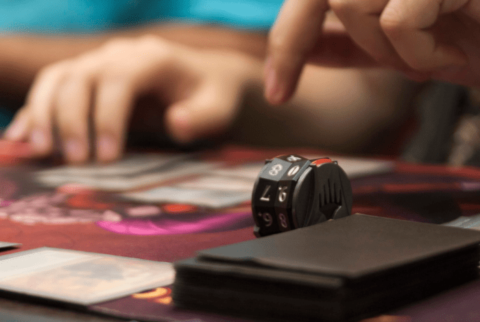 Closeup of hands and a board game.