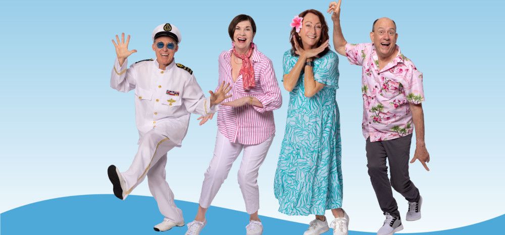 Four people laughing and dancing